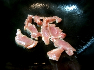 薄く切った豚ヒレ肉を炒める