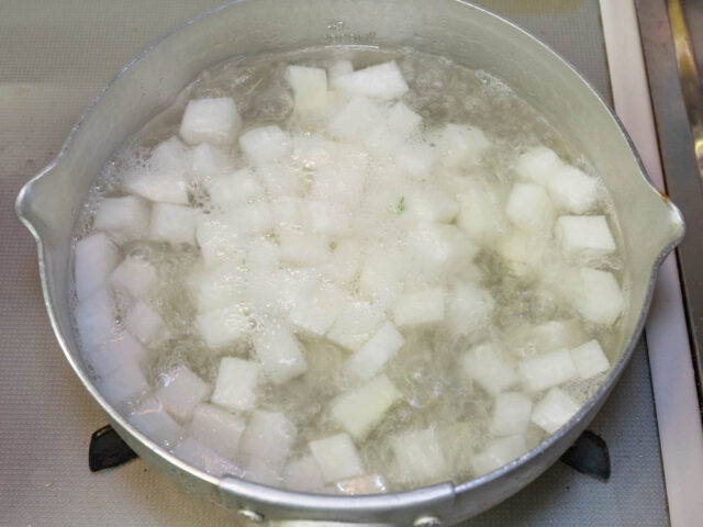 鍋で大根を下茹でする写真