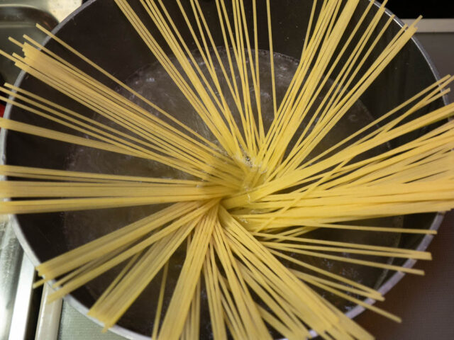 鍋にお湯を沸かしてパスタを入れた写真