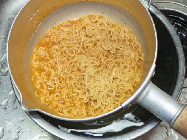 ラーメンを茹でた鍋を、水をはったボウルに浮かべて冷やす写真
