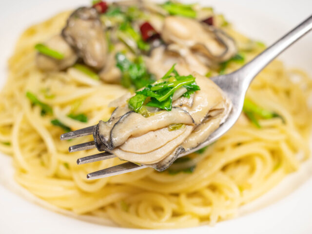 牡蠣をフォークにのせた写真