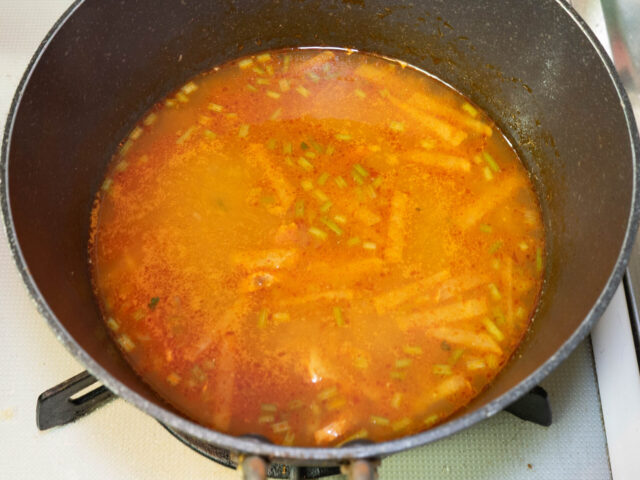 鍋のスープにトムヤムクンペーストを溶かした写真