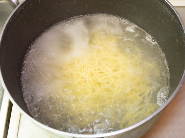 鍋にお湯を沸かして麺を茹でる写真