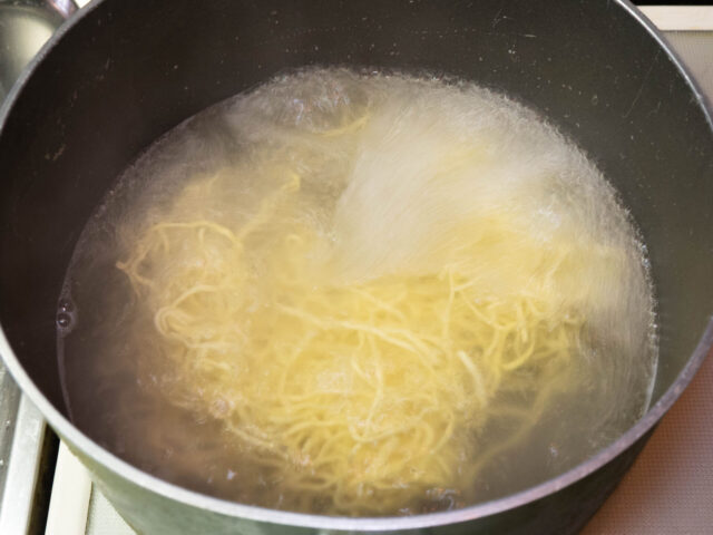 鍋のお湯を沸かし、中華麺を茹でる写真